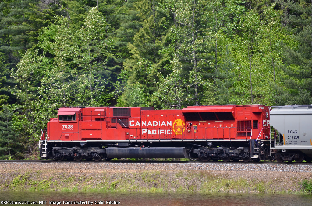 CP 7028, trailing SD 70ACU on an empty E/B unit potash train, just east of Taft Rd., near Malakwa, B.C